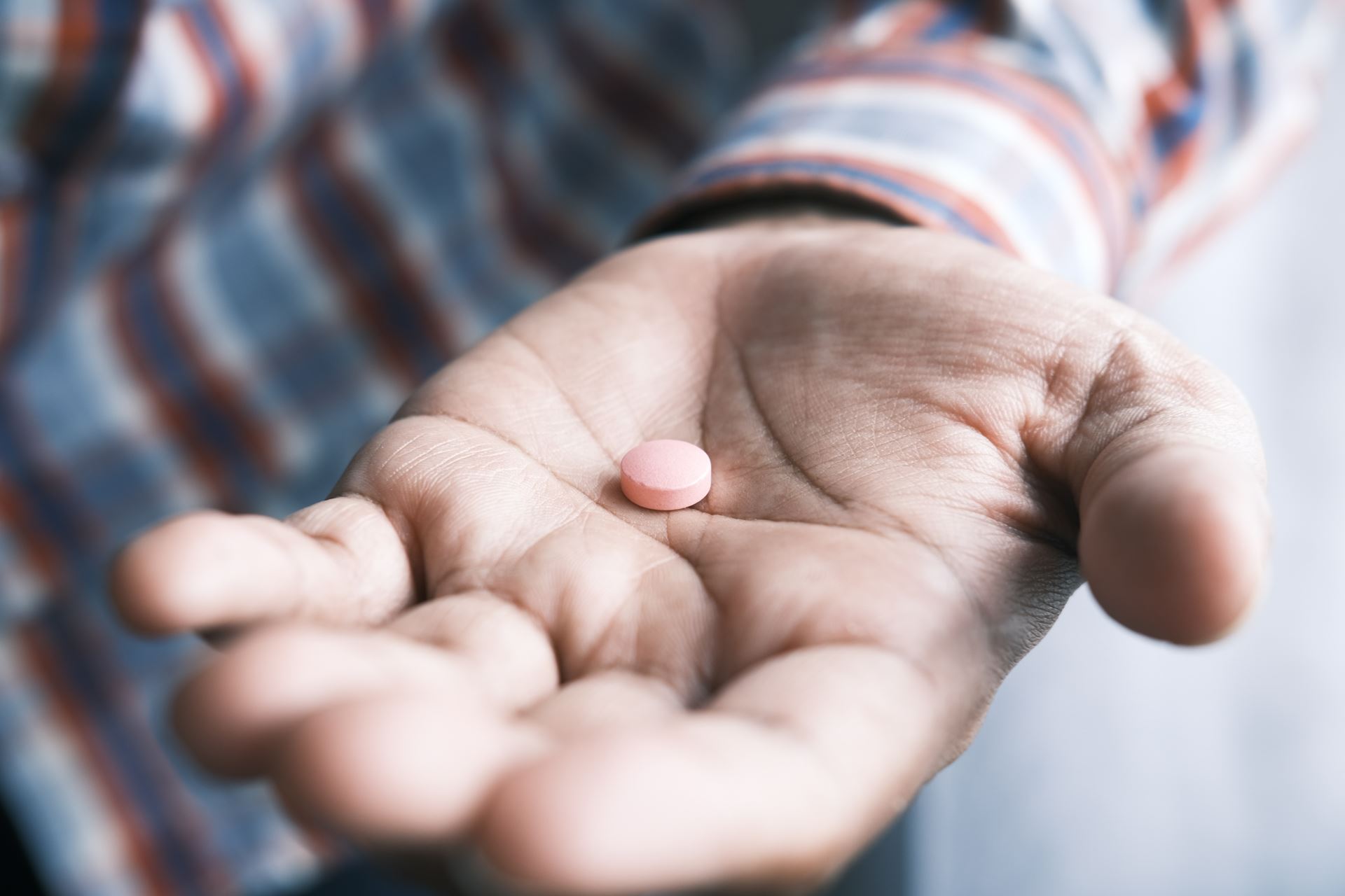 a person holding a pill