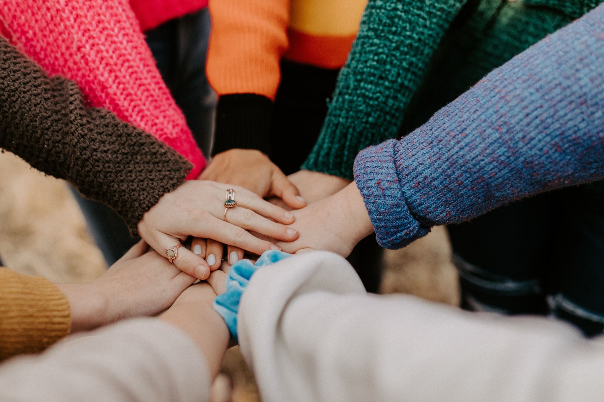 group of hands in a circle